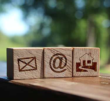 Three blocks with a mail, at symbol and house icon